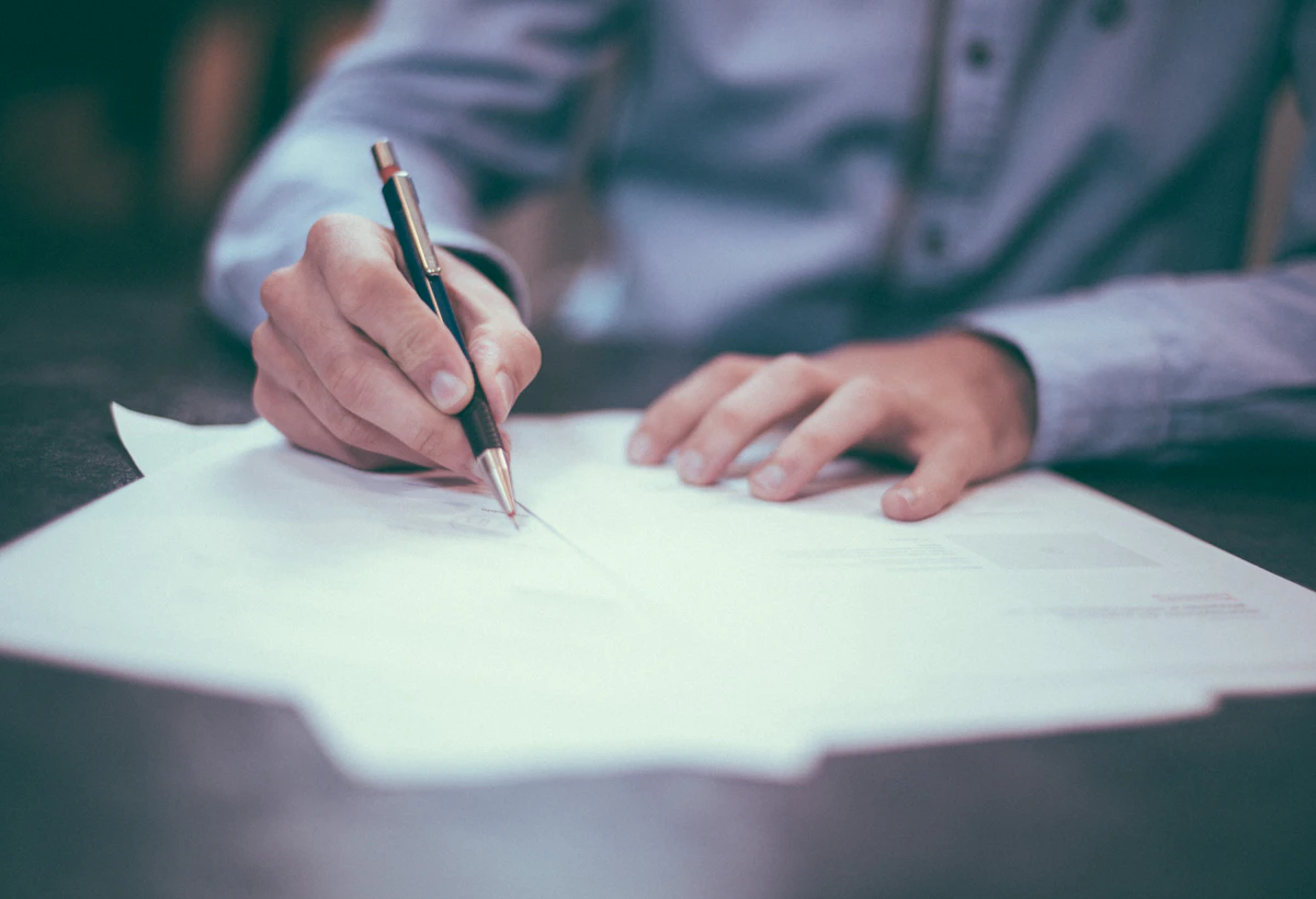 A person writing on a paper document